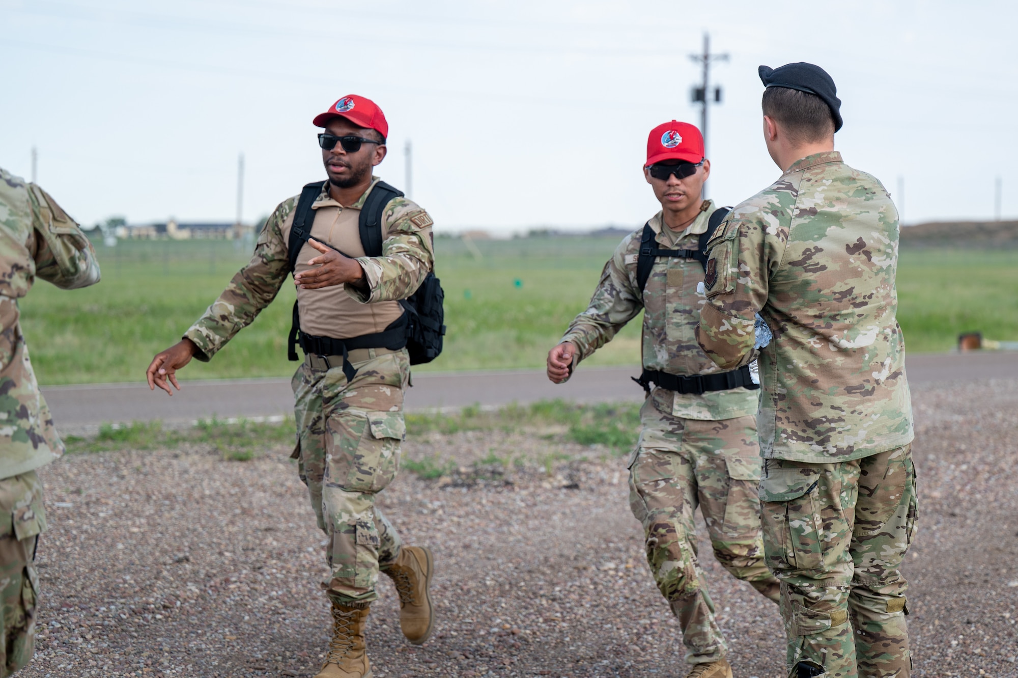 U.S. Air Force Staff Sgt. Trystan Davis, 741st Missile Security Forces Squadron fire team leader, hands out water bottles to participants in a Norwegian Foot March at Malmstrom Air Force Base, Montana, May 26, 2026.