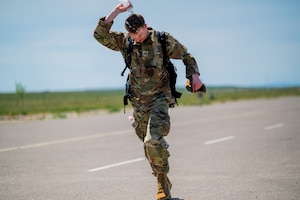A participant in a Norwegian Foot March dumps water over his head as he approaches the finish line at Malmstrom Air Force Base, Montana, May 26, 2026.