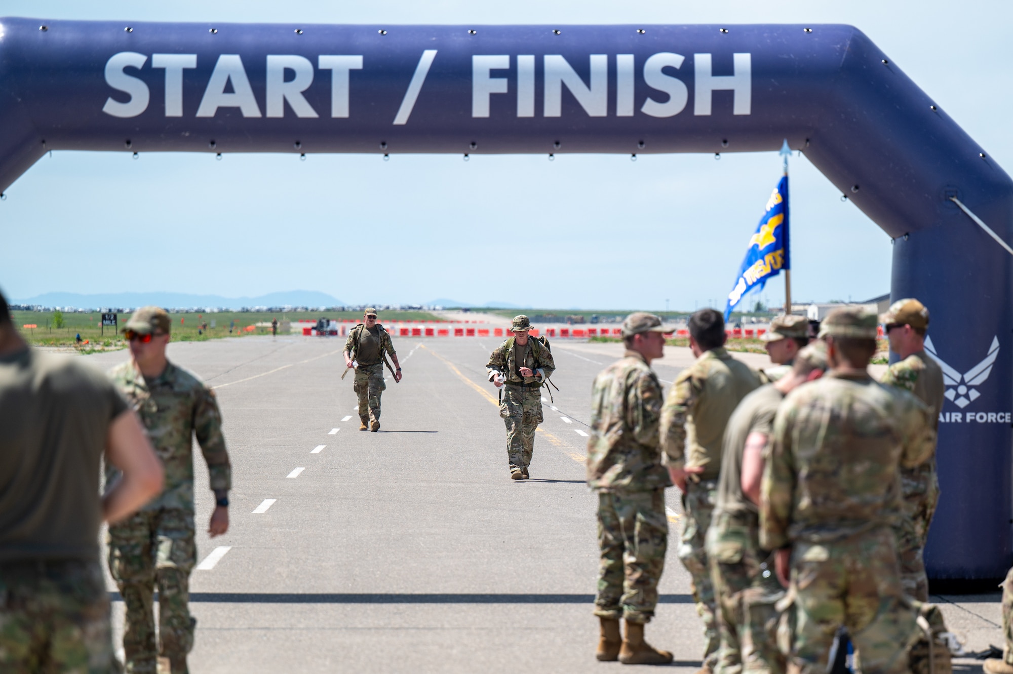 Participants in a Norwegian Foot March approach the finish line after more than four hours of rucking at Malmstrom Air Force Base, Montana, May 26, 2026.