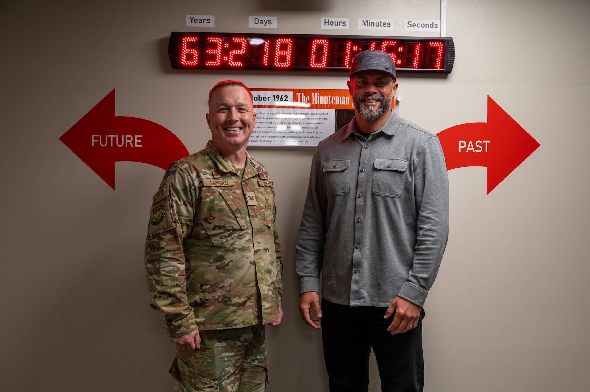 The Under Secretary of the Air Force poses for a photo with a uniformed service member.