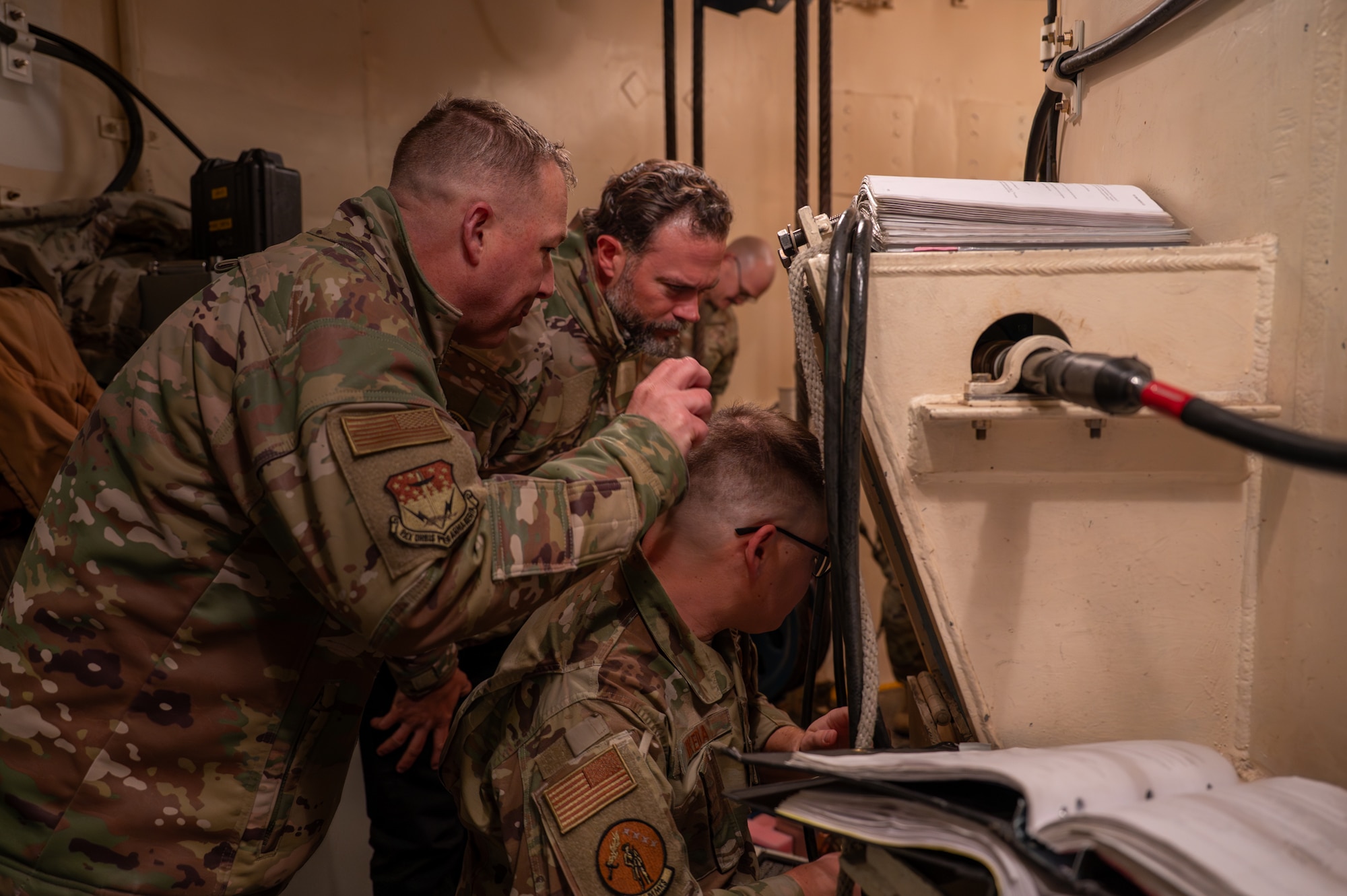 The Under Secretary of the Air Force and a group of military personnel observe a Minuteman III intercontinental ballistic missile.