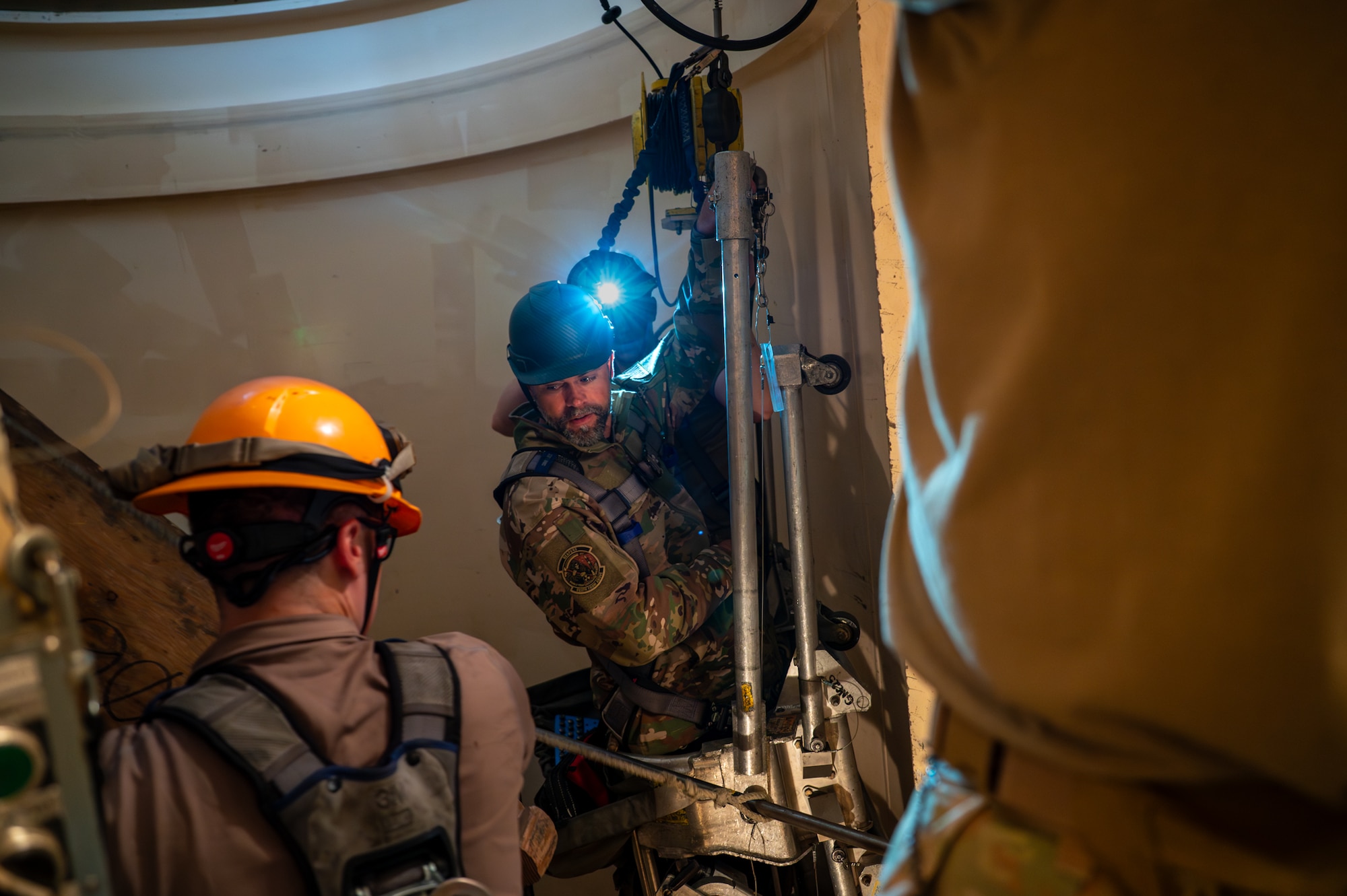 The Under Secretary of the Air Force is in a launch facility observing maintenance.