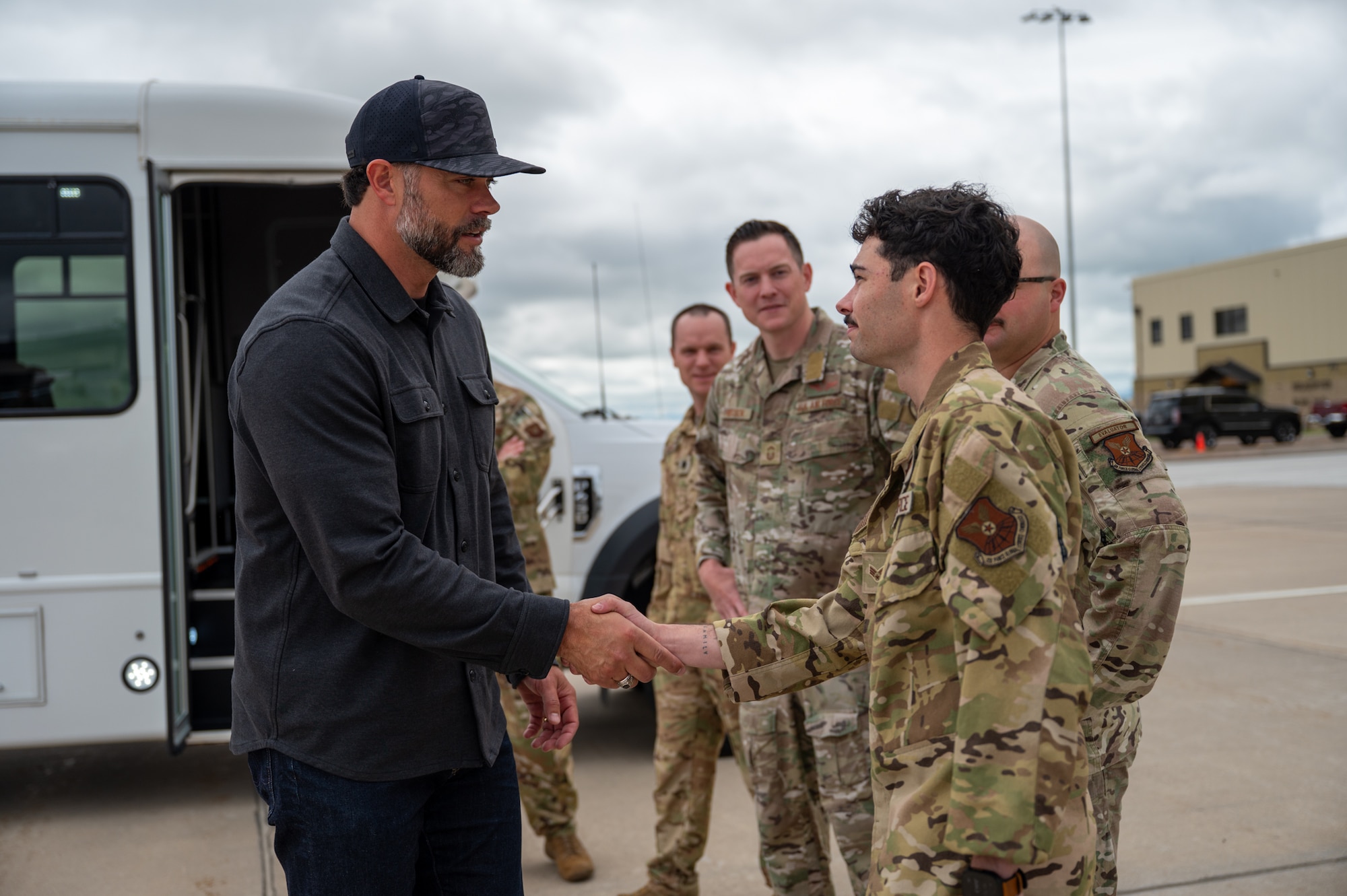 The Under Secretary of the Air Force shakes hands with a uniformed service member.