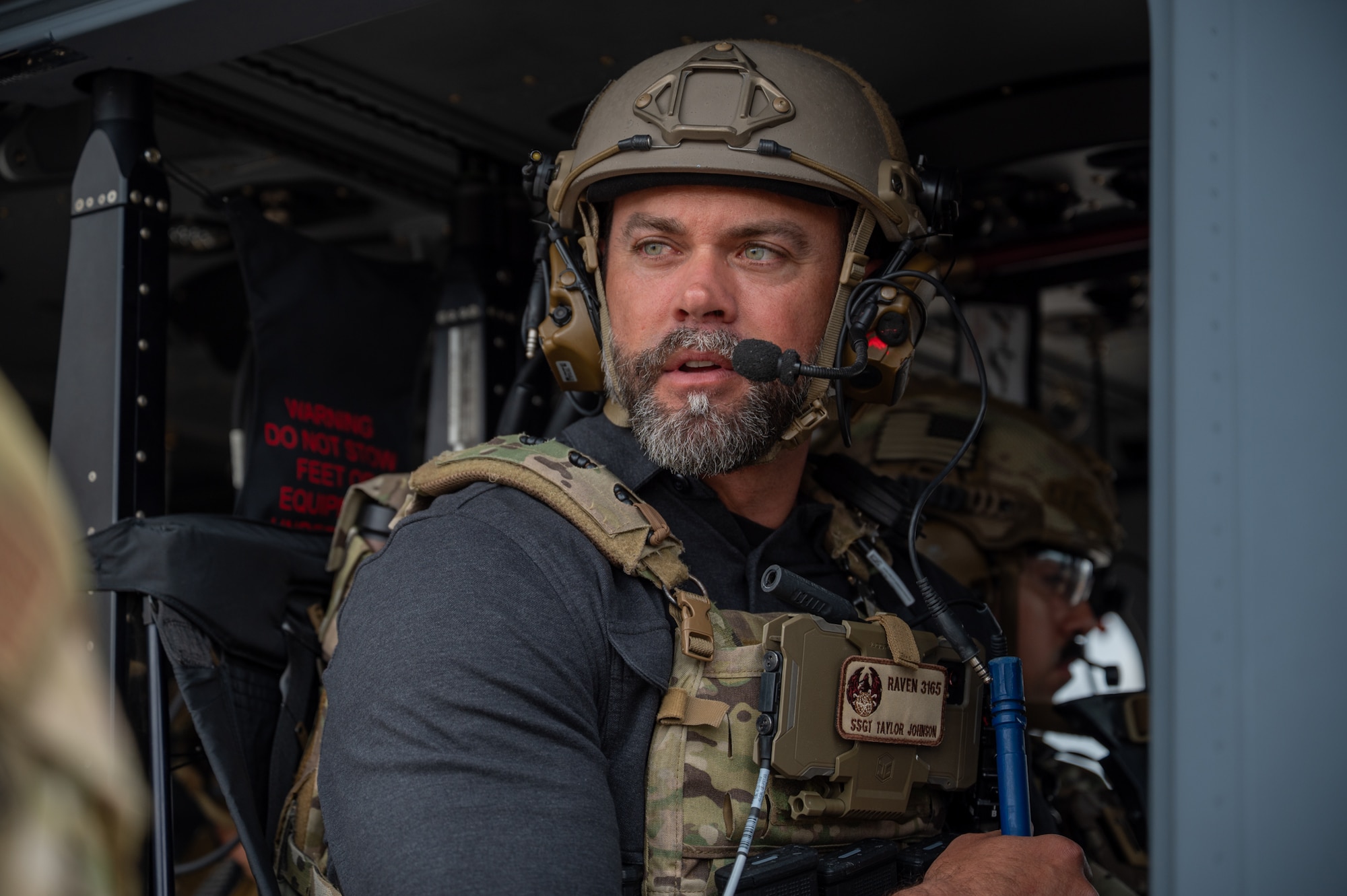 The Under Secretary of the Air Force sits in a helicopter.
