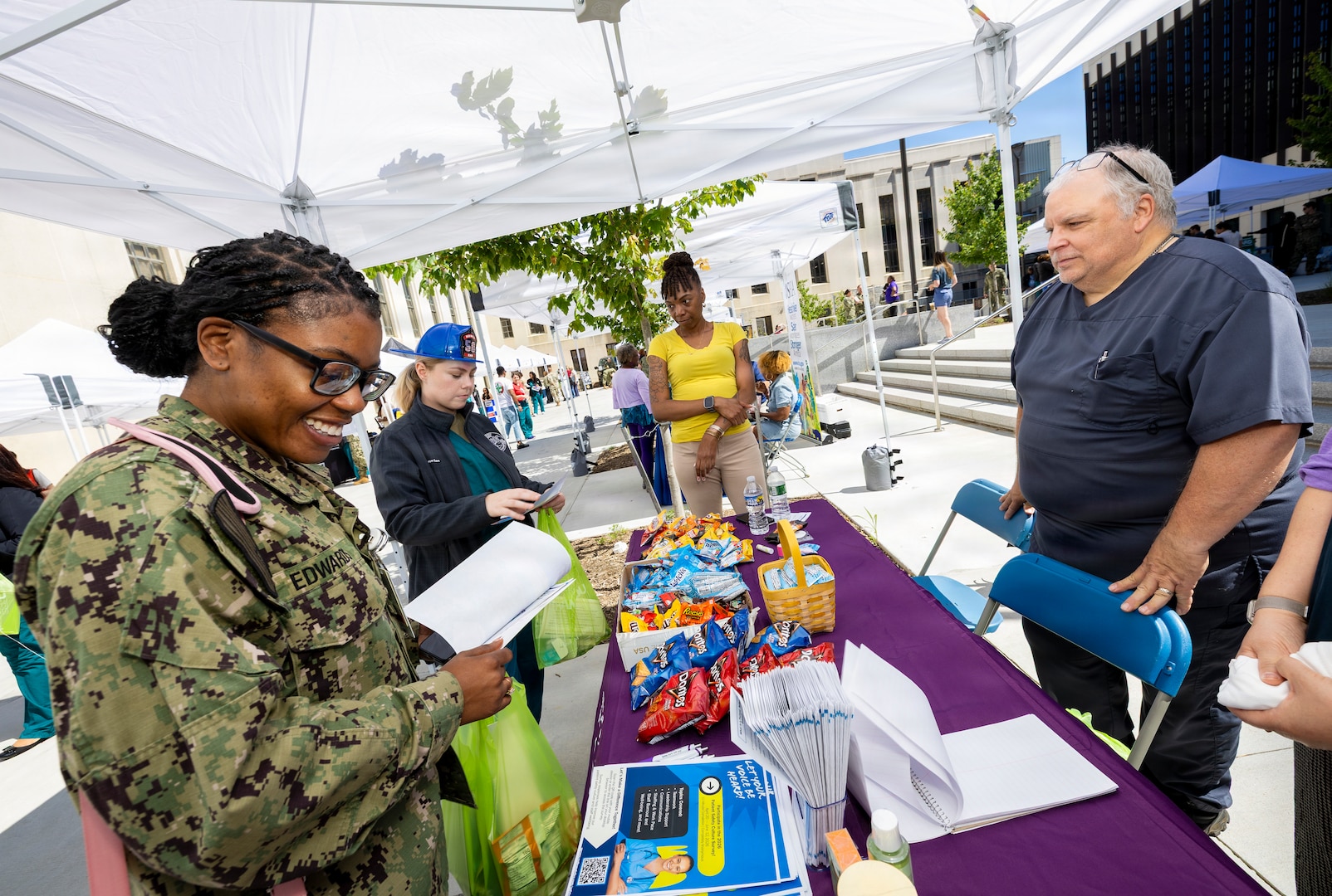 A U.S. Navy Sailor looks at items on a table.