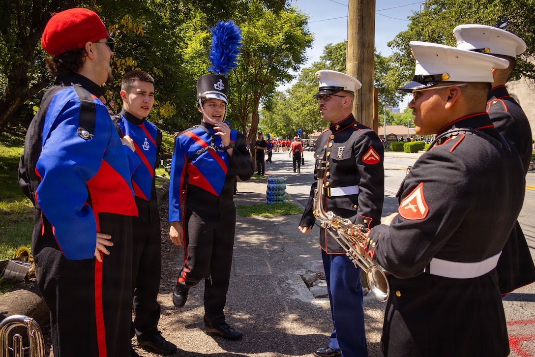 U.S. Marines with the Marine Corps Recruit Depot Parris Island Marine Band, march through the streets of Louisville, KY., during the Zoeller Pump Company Pegasus Parade on Apr. 26, 2026. The Parris Island Marine Band performed musical numbers alongside local organizations and performers for Louisville residents celebrating the Kentucky Derby. (U.S. Marine Corps photo by Lance Cpl. Jacob Claudell)