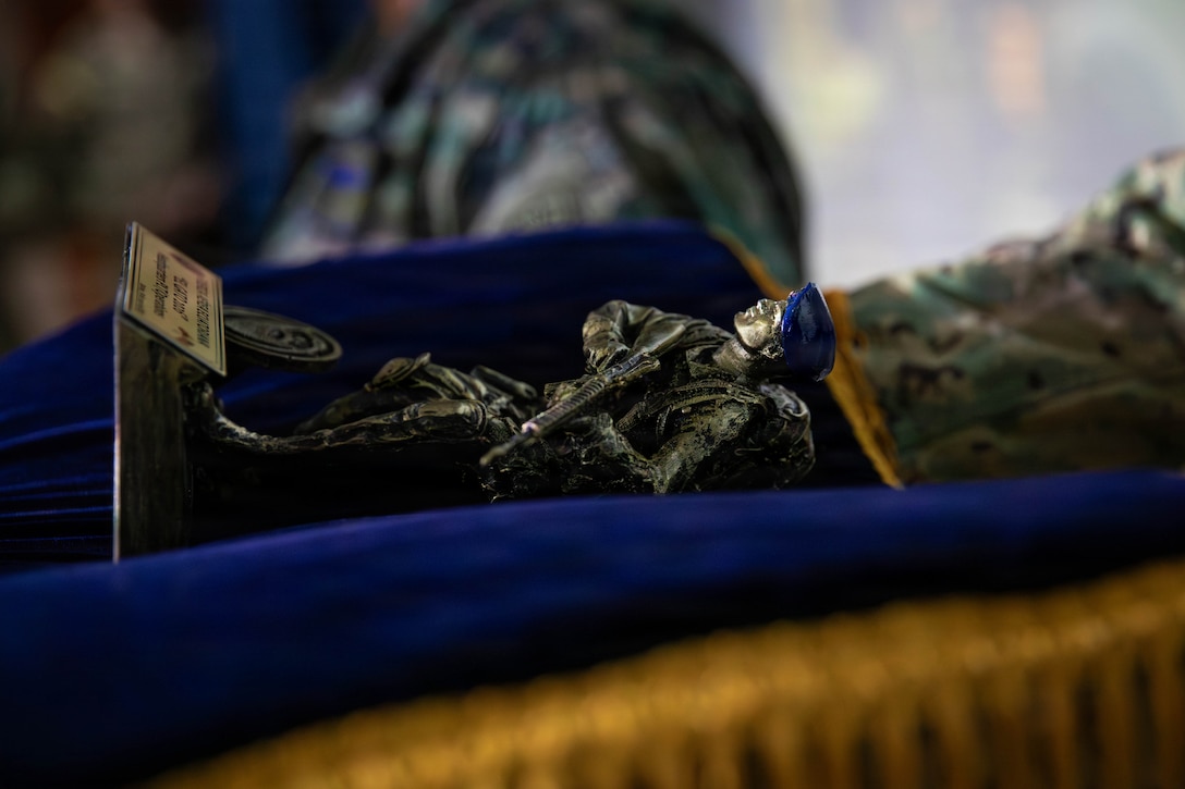 An Ecuadorian airman presents a commemorative figure to the platoon leader and platoon sergeant of 2nd Platoon, 940th Military Police Company, during the closing ceremony for Exercise El Gato 2026 in Salinas, Ecuador, May 19, 2026.
