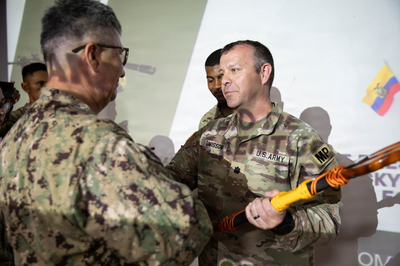 Lt. Col. Brandon Davisson, commander of the 198th Military Police Battalion, receives a commemorative trident from the Ecuadorian Navy during the closing ceremony for Exercise El Gato 2026 in Salinas, Ecuador, May 19, 2026.