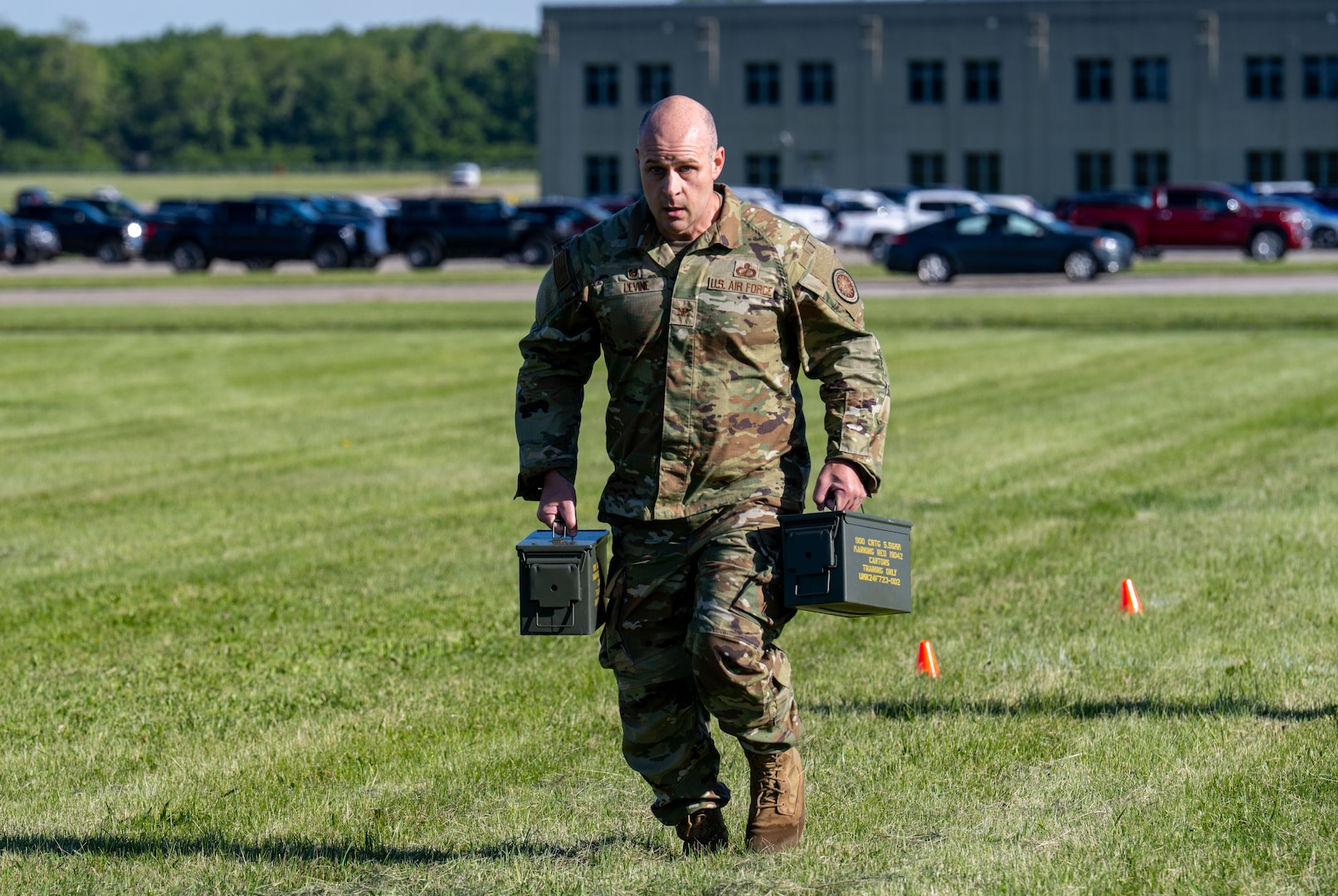 A man wearing a military uniform participates in an obstacle course