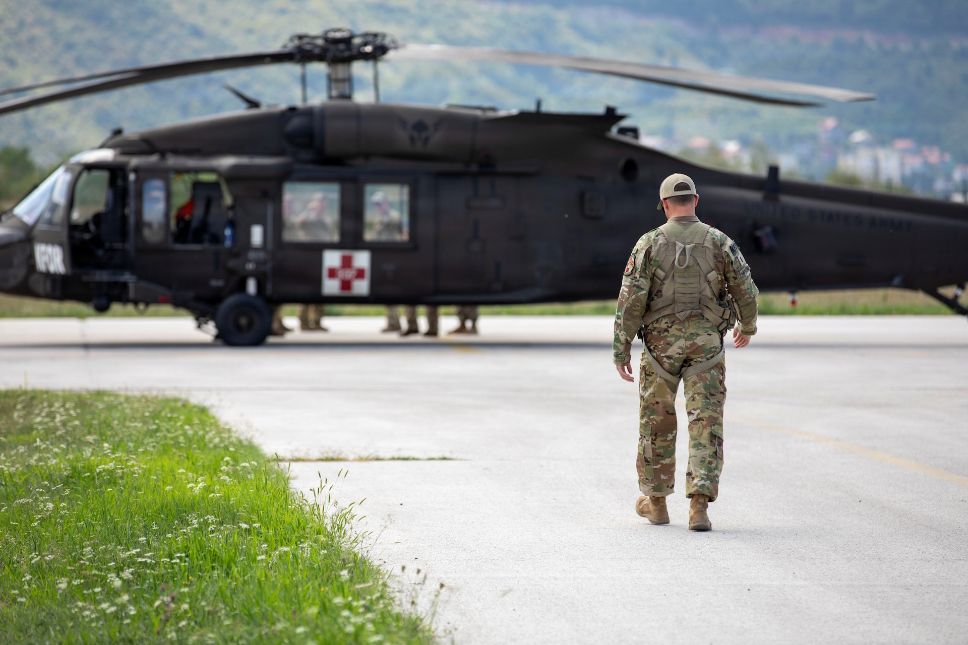 U.S. Army 1st Lieutenant Dustin Haubner with Task Force Griffin (KFOR 35, TF Aviation) walks toward a UH-60 Black Hawk during their deployment to Kosovo.