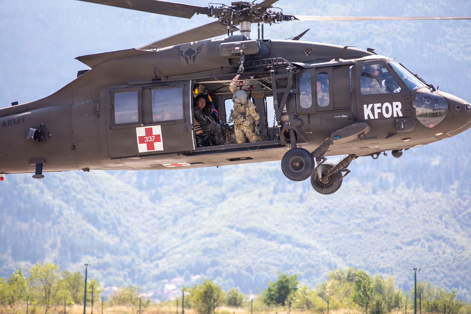 U.S. Army 1st Lieutenant Dustin Haubner with Task Force Griffin (KFOR 35, TF Aviation) looks toward the ground as the UH-60 Black Hawk takes off during ther deployment to Kosovo.