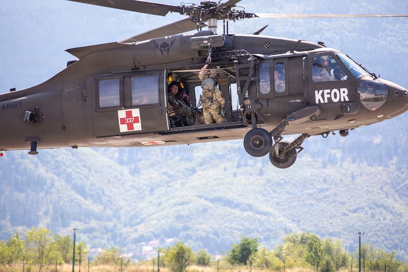 U.S. Army 1st Lieutenant Dustin Haubner with Task Force Griffin (KFOR 35, TF Aviation) looks toward the ground as the UH-60 Black Hawk takes off during ther deployment to Kosovo.