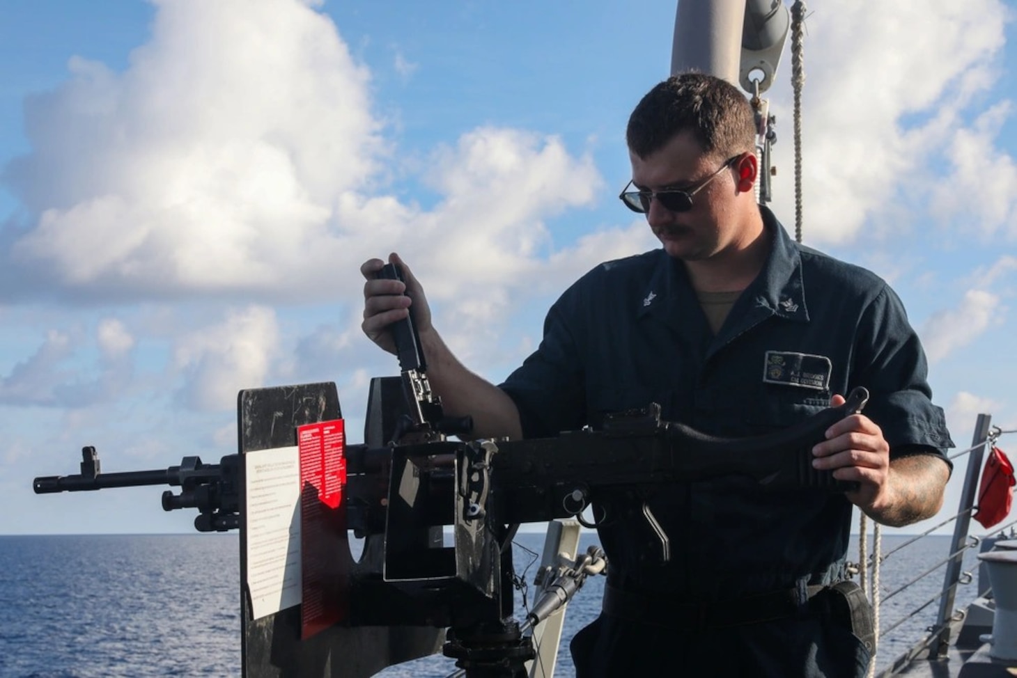 Sailors aboard the USS John Finn conduct an M240 gunshoot in the South China Sea