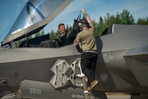 U.S. Air Force Staff Sgt. Christian Cornwell, 48th Equipment Maintenance Squadron, assists Capt. Logan Halverson, 493rd Fighter Squadron F-35A Lightning II pilot, during Ramstein Flag 26 at Pirkkala Air Base, Finland, June 8, 2026. RAFL26 provides the 48th Fighter Wing an opportunity to validate Agile Combat Employment concepts, generating combat power from geographically dispersed locations alongside NATO Allies. (U.S. Air Force photo by Tech. Sgt. Christine Groening)