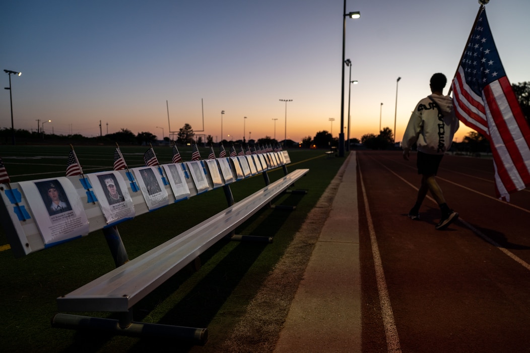 U.S. Air Force Airman 1st Class Malic ONeal, 17th Security Forces Squadron installation entry controller, carries a U.S. flag during a 24-hour National Police Week march at Goodfellow Air Force Base, Texas, May 11, 2026. Defenders took part in the 24-hour ruck as part of Police Week, honoring members of law enforcement and those that lost their lives in the line of duty. (U.S. Air Force photo by Senior Airman Renee Nicole S.N. Finona)