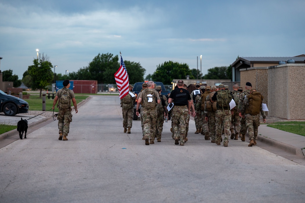 Members from across the 17th Training Wing conduct a fallen hero's ruck during National Police Week at Goodfellow Air Force Base, Texas, May 15, 2026. The ruck served as a physical tribute to law enforcement officers and defenders who made the ultimate sacrifice in the line of duty. (U.S. Air Force photo by Senior Airman James Salellas)