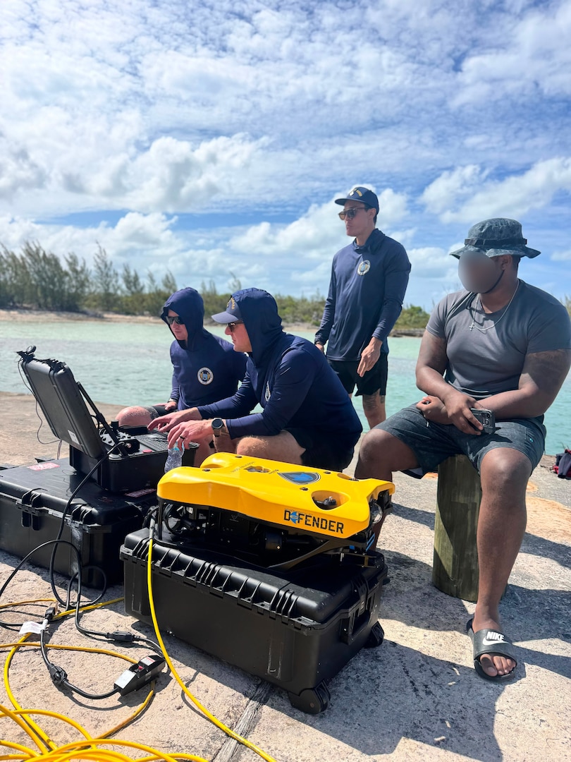 U.S. Coast Guard Divers, CGIS Investigators and RBDF personnel utilize a remotely operated underwater vehicle to search for a missing person during a CGIS investigation in the Bahamas, Jun. 4, 2026. The Coast Guard's efforts were supported by the Royal Bahamas Police Force, the Royal Bahamas Defence Force, and K-9 Maggie from the Broward County Sheriff's Office. Coast Guard units included the Coast Guard Cutter Margaret Norvell (WPC-1105), home ported in Miami, Florida, and Coast Guard divers. (U.S. Coast Guard photo by Chief Warrant Officer Adam Harris)