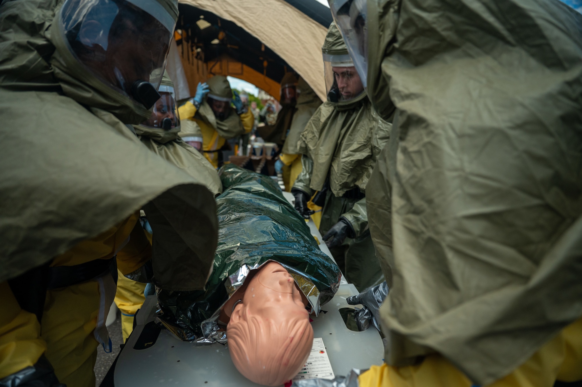 Airmen treat a medical manikin.