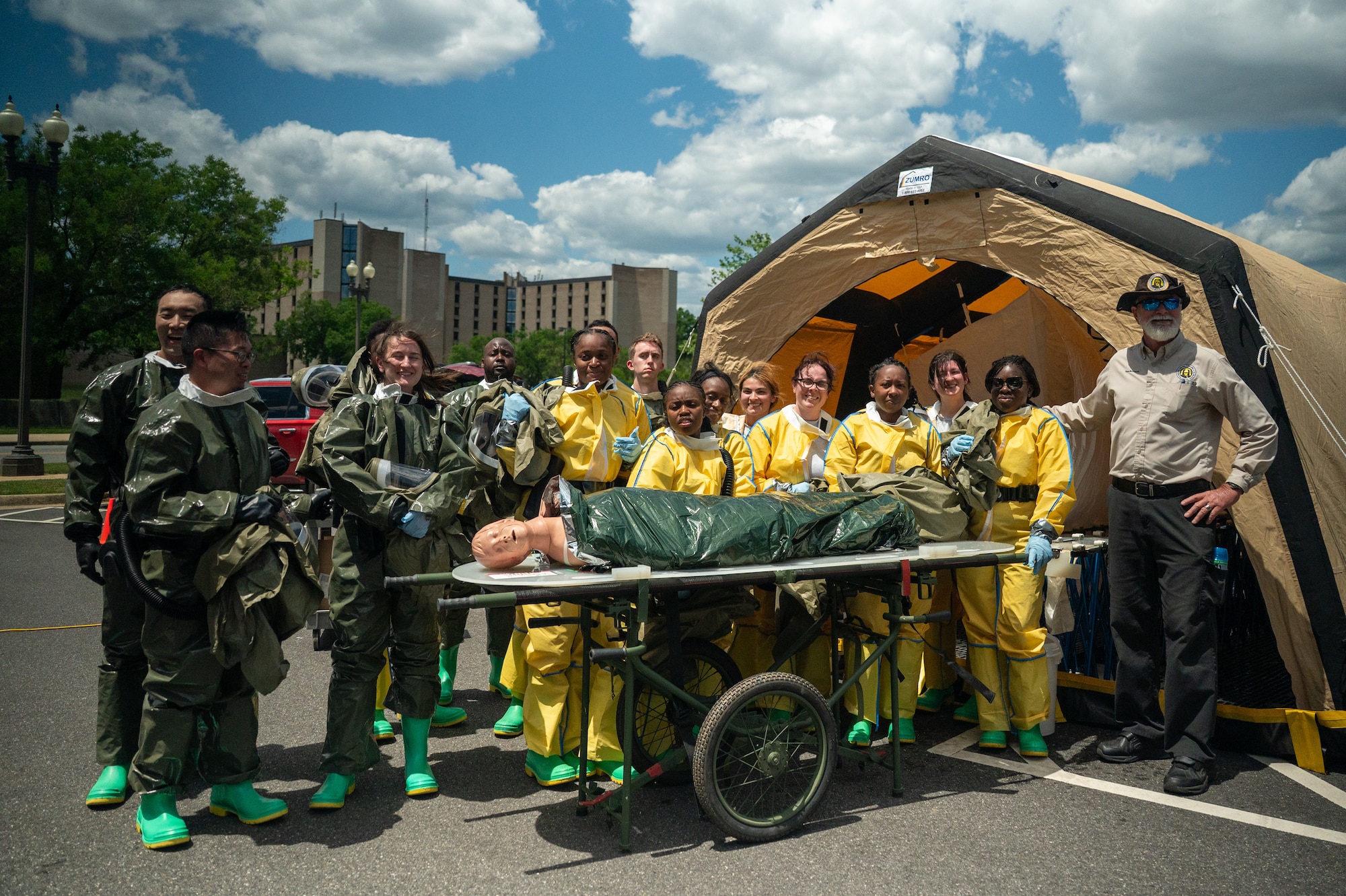 Airmen pose for a photo in hazmat gear.