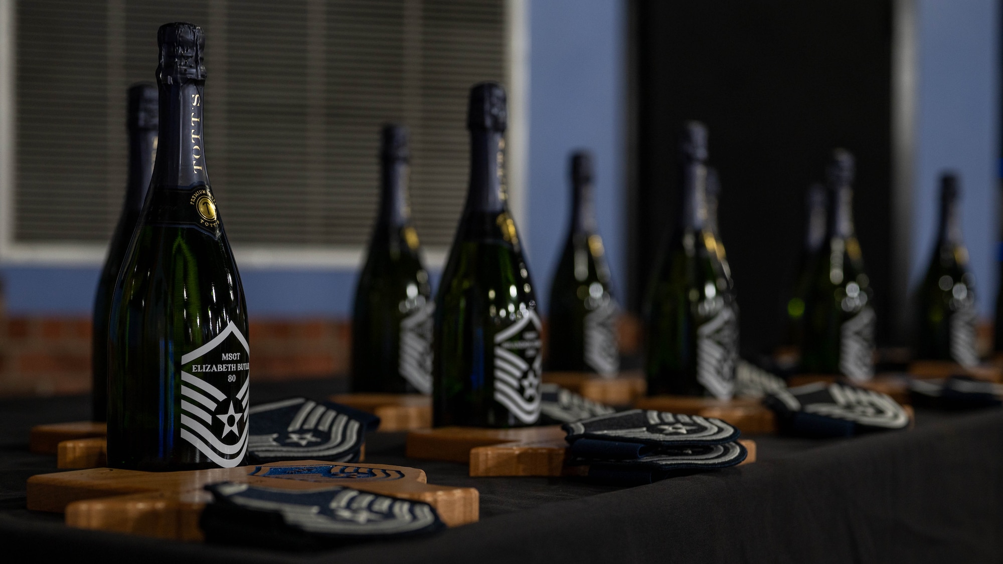 Custom plaques, champagne bottles, and rank insignias recognizing Laughlin’s newest master sergeant selects are arranged for presentation.