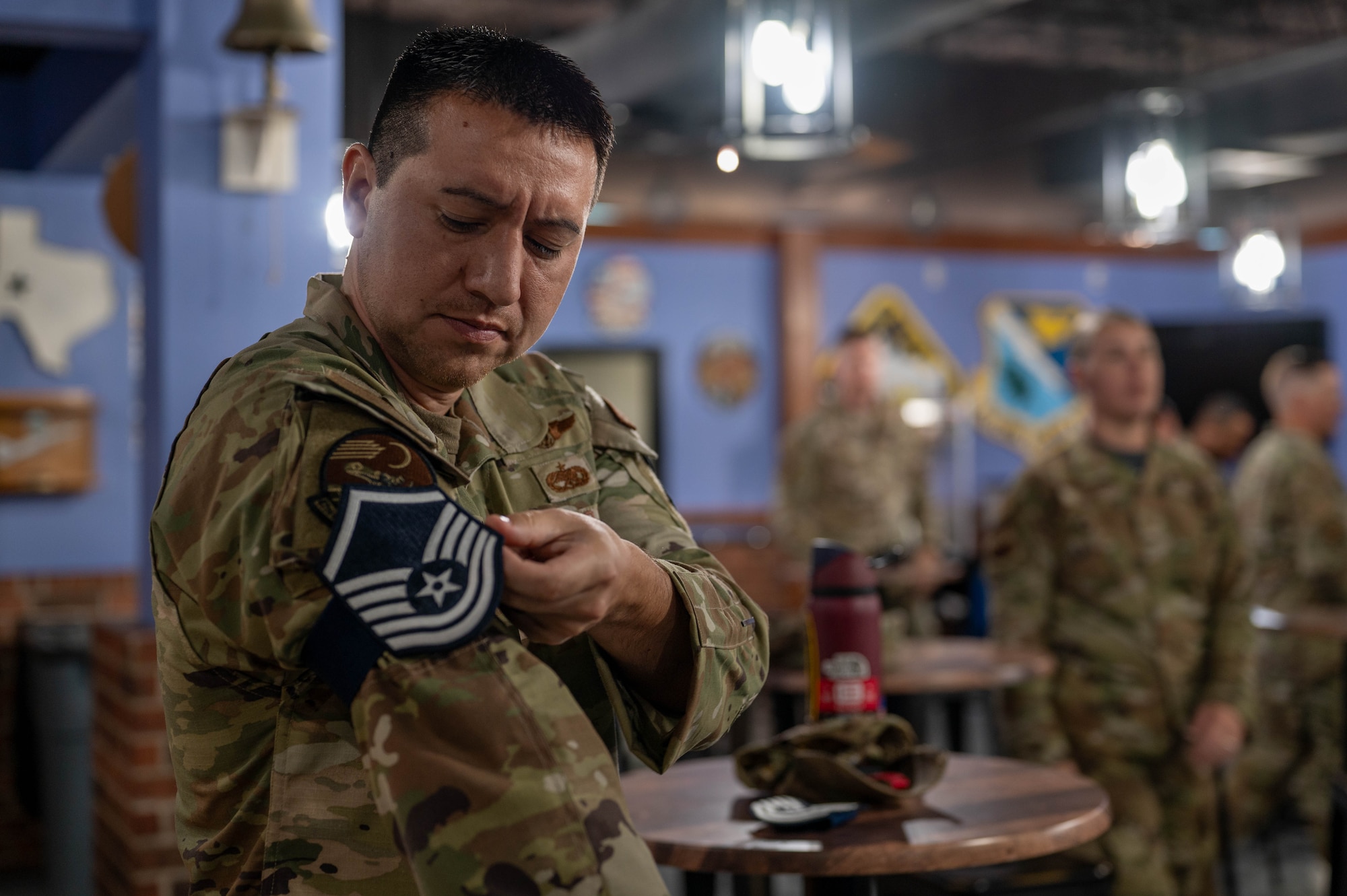 Tech. Sgt. Antani Walling equips a temporary master sergeant rank on his sleeve.
