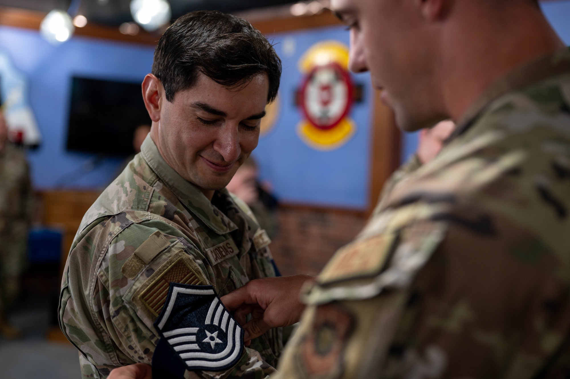 Tech. Sgt. Marco Cardenas equips a temporary master sergeant rank on his sleeve.