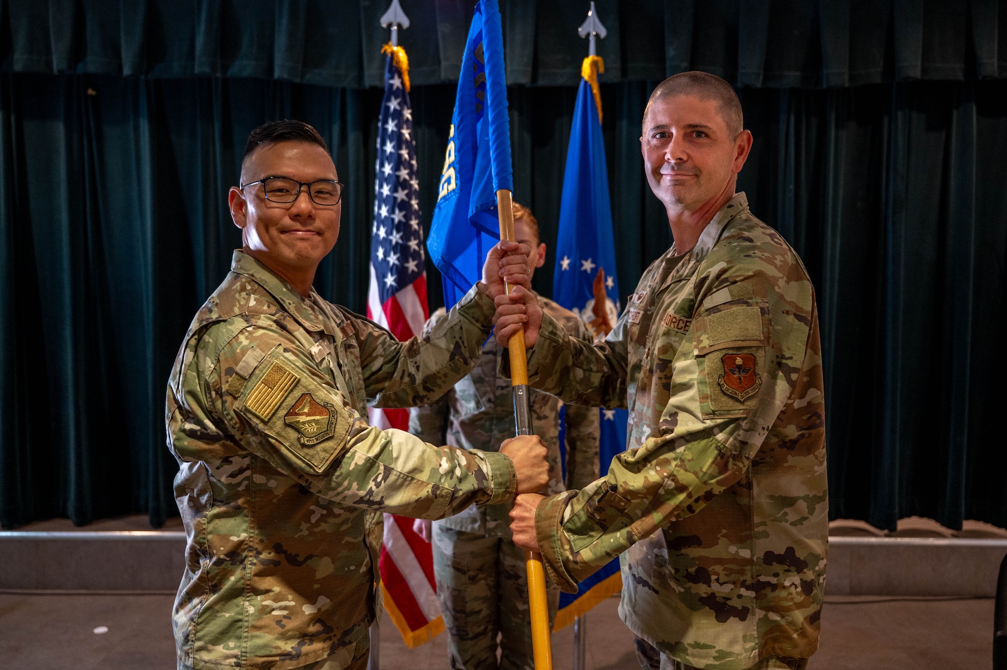 Col. Peter Joo presents the squadron guidon to Maj. Brian Cockroft.