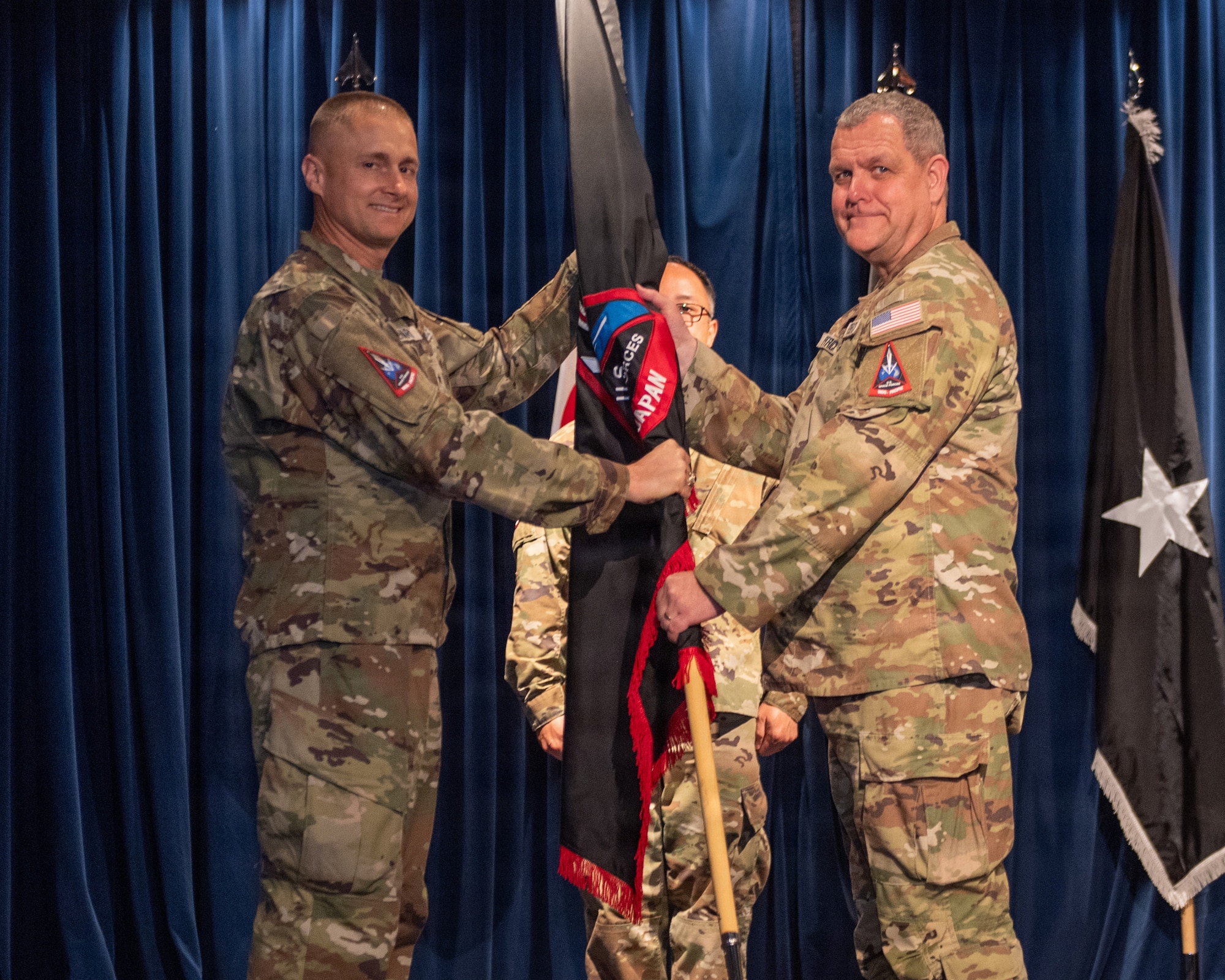 U.S. Space Force Brig. Gen. Brian Denaro, U.S. Space Forces - Indo-Pacific commander, presents the guidon to Col. John Patrick, incoming commander of U.S. Space Forces - Japan, during the U.S. Space Forces - Japan change of command ceremony at Yokota Air Base, Japan, June 3, 2026.