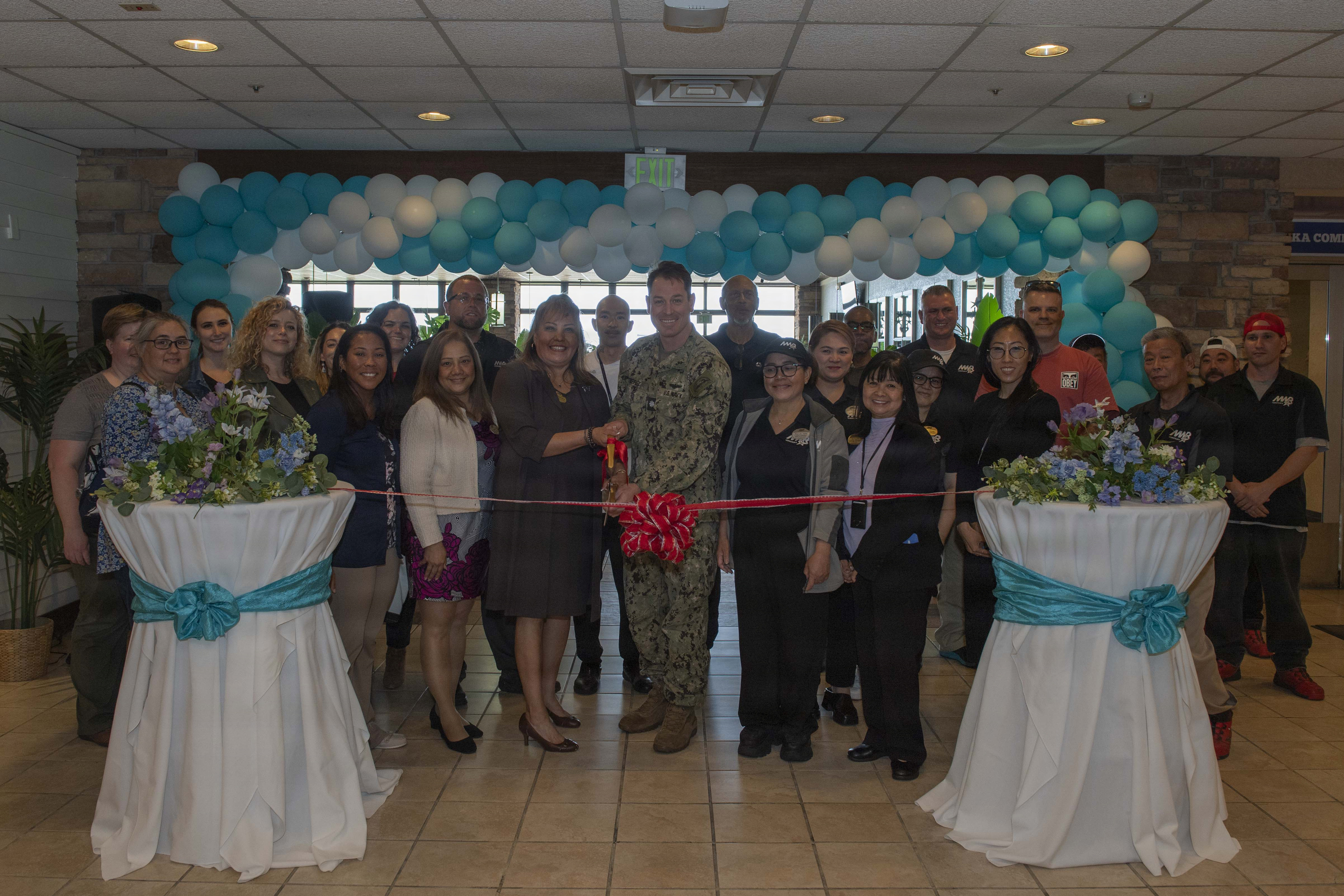 Cmdr. Patrick Gutierrez, Commander, Fleet Activities Yokosuka (CFAY) chief staff officer, and Morale, Welfare and Recreation’s Food and Beverage Director Richarda Rodriguez cut the ceremonial ribbon for the opening of Seaside Café at CFAY, May 4, 2026. For more than 80 years, CFAY has provided, maintained, and operated base facilities and services in support of the U.S. 7th Fleet's forward-deployed naval forces, tenant commands, and thousands of military and civilian personnel and their families.