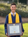 Phoenix Juneau Austin, 16, holds his Bachelor of Business Management diploma during a graduation ceremony at Western Governors University in Millcreek, Utah, Oct. 1, 2025. Austin is preparing to attend Air Force Officer Training School as part of his long-term goal of commissioning as a cybersecurity and/or acquisitions officer. (Courtesy photo by Dave Austin)