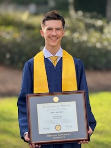 Phoenix Juneau Austin, 16, holds his Bachelor of Business Management diploma during a graduation ceremony at Western Governors University in Millcreek, Utah, Oct. 1, 2025. Austin is preparing to attend Air Force Officer Training School as part of his long-term goal of commissioning as a cybersecurity and/or acquisitions officer. (Courtesy photo by Dave Austin)