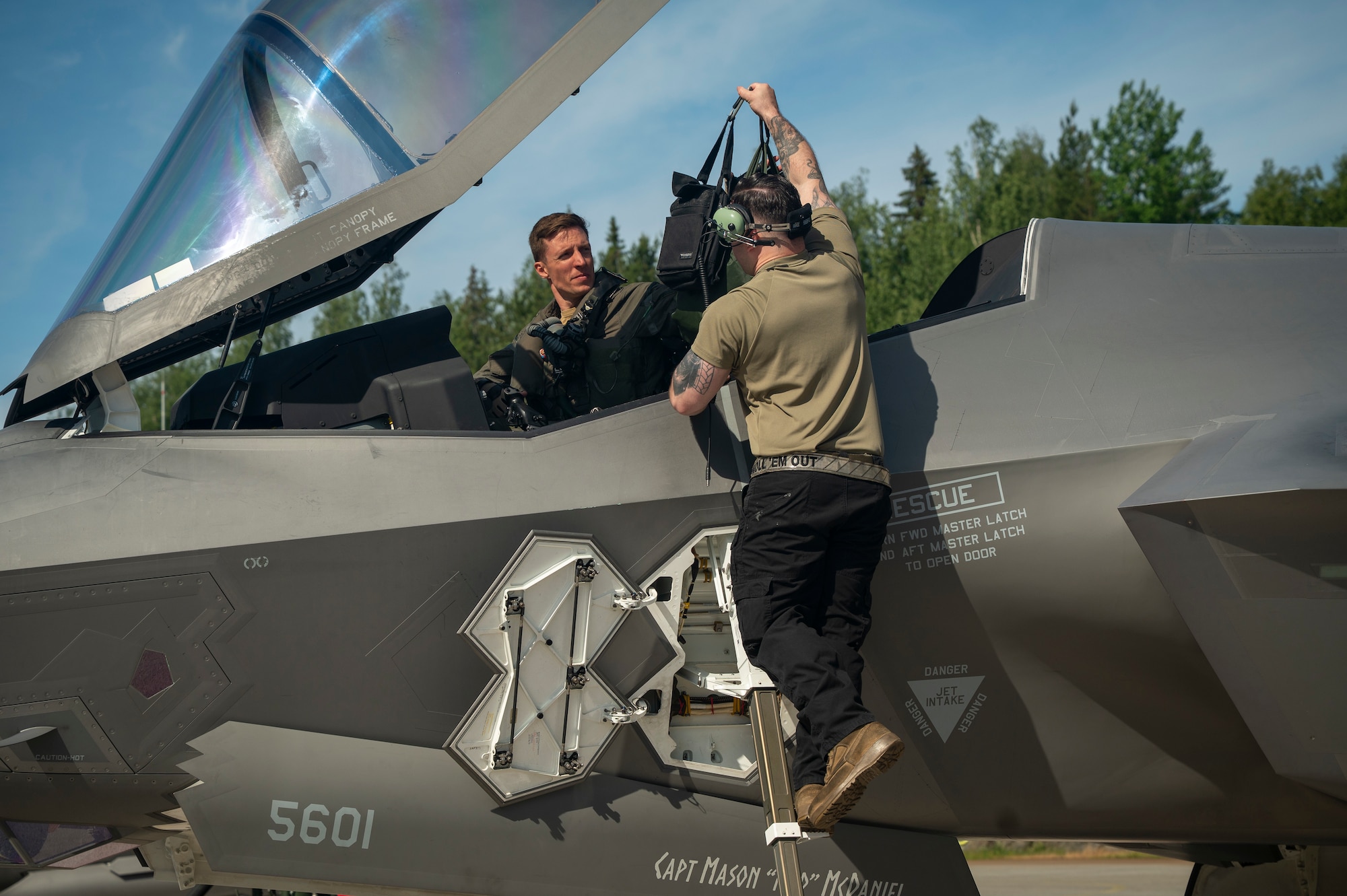 U.S. Air Force Staff Sgt. Christian Cornwell, 48th Equipment Maintenance Squadron, assists Capt. Logan Halverson, 493rd Fighter Squadron F-35A Lightning II pilot, during Ramstein Flag 26 at Pirkkala Air Base, Finland, June 8, 2026. RAFL26 provides the 48th Fighter Wing an opportunity to validate Agile Combat Employment concepts, generating combat power from geographically dispersed locations alongside NATO Allies. (U.S. Air Force photo by Tech. Sgt. Christine Groening)