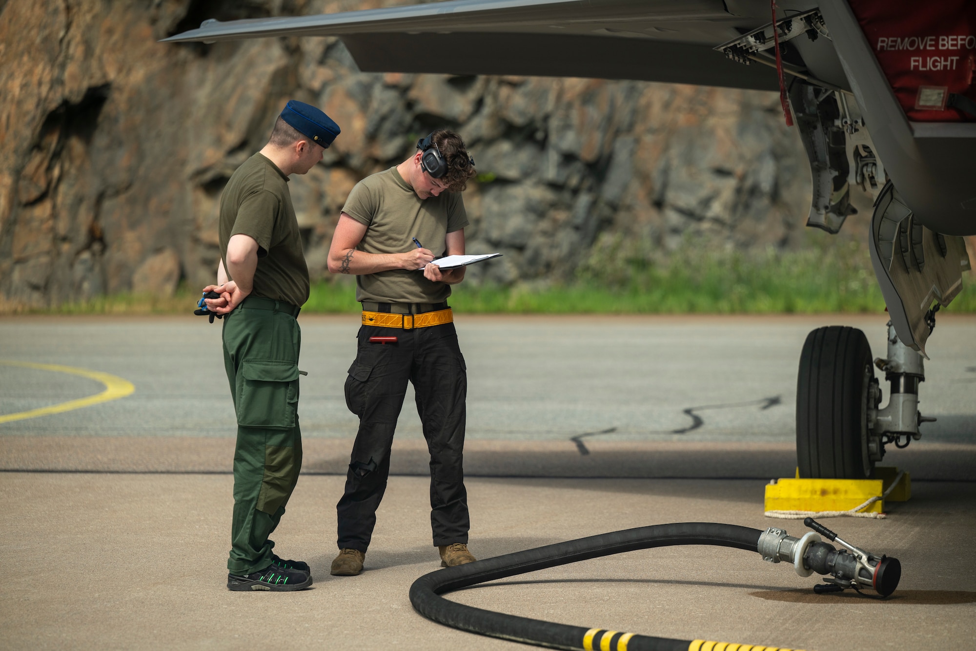 A Finnish Air Force Airman and U.S. Air Force Airman 1st Class Dylan Montgomery, 493rd Fighter Generation Squadron crew chief, perform pre-refueling documentation during Ramstein Flag 26 at Pirkkala Air Base, Finland, June 8, 2026. Operating alongside Finnish counterparts during Ramstein Flag 26 enhances interoperability and demonstrates the Alliance's commitment to shared security in the Eastern Flank. (U.S. Air Force photo by Tech. Sgt. Christine Groening)