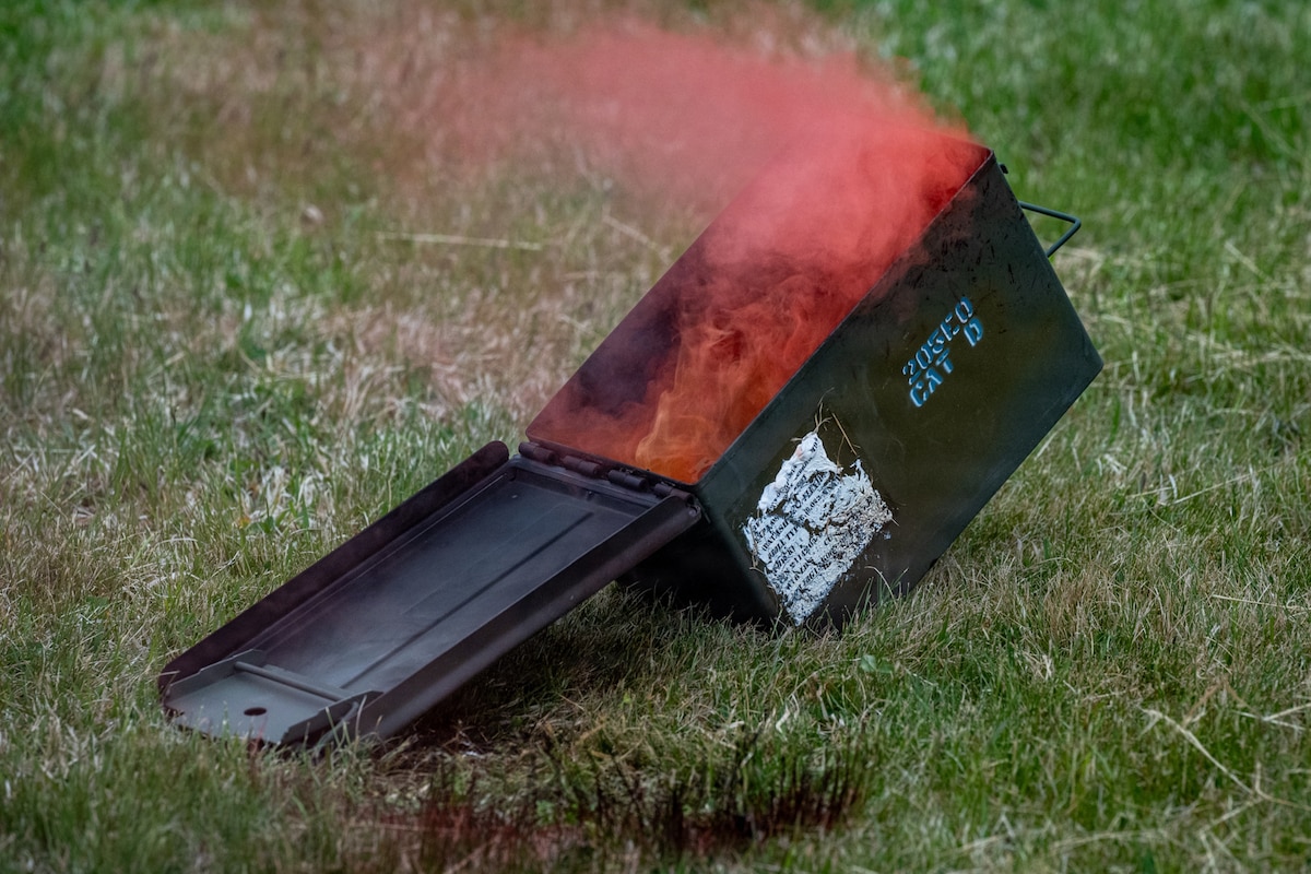 A smoke canister lies on the ground during a drone attack exercise at Misawa Air Base, Japan, May 20, 2026. The scenario used props, simulated explosion sounds and small unmanned aircraft systems to create a realistic training environment for Airmen responding to casualties, hazards and movement challenges. (U.S. Air Force photo by Senior Airman Andre Medina)