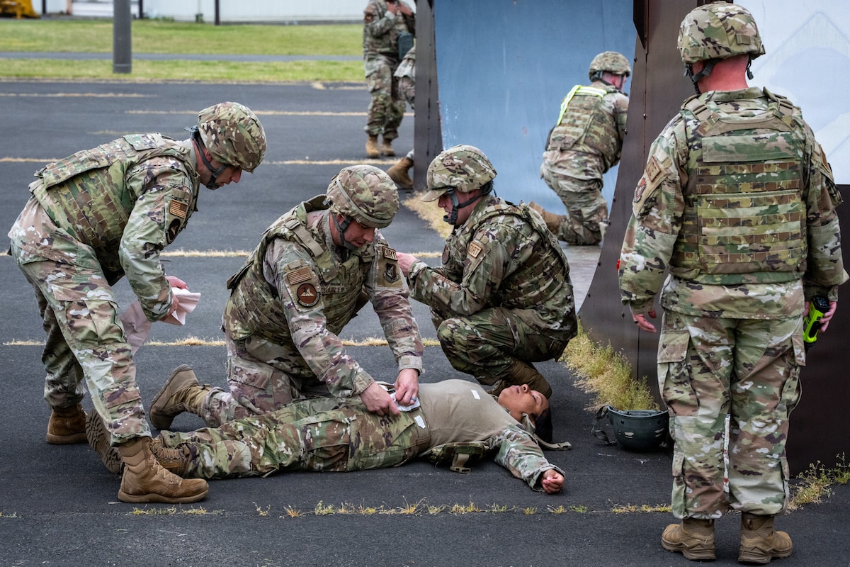 U.S. Airmen assigned to the 35th Civil Engineer Squadron perform Tactical Combat Casualty Care during a small unmanned aircraft system attack exercise at Misawa Air Base, Japan, May 20, 2026. The scenario tested Airmen’s ability to provide immediate casualty care and apply lifesaving skills in a simulated threat environment. (U.S. Air Force photo by Senior Airman Andre Medina)