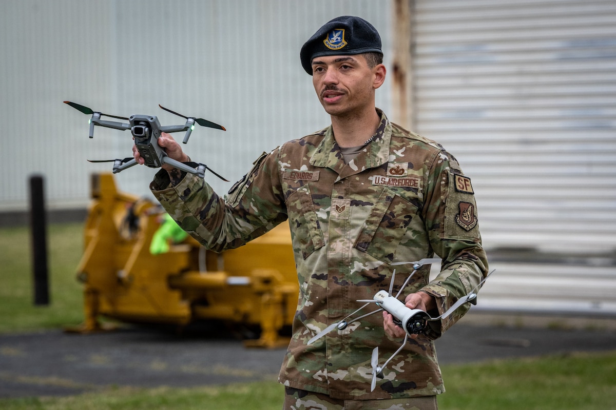 U.S. Air Force Staff Sgt. Deante Edward, 35th Security Forces Squadron counter-small unmanned aircraft system noncommissioned officer in charge, briefs 35th Civil Engineer Squadron Airmen after a drone attack exercise at Misawa Air Base, Japan, May 20, 2026. Edwards gave Airmen a closer look at unmanned aircraft system threat capabilities, reinforcing knowledge to improve response actions and help protect personnel during real-world incidents. (U.S. Air Force photo by Senior Airman Andre Medina)