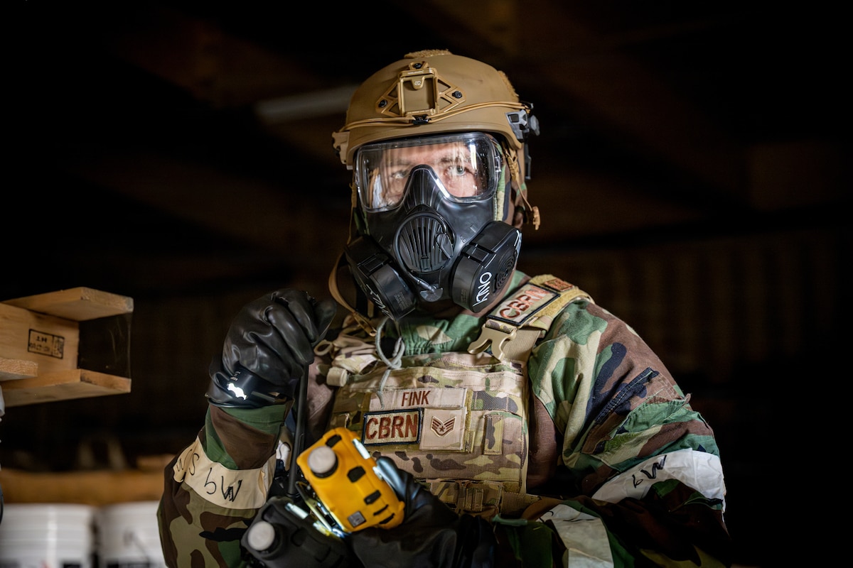 U.S. Air Force Staff Sgt. James Fink, 35th Civil Engineer Squadron Emergency Management noncommissioned officer in charge of logistics and training, scans the inside of a storage house for a simulated small unmanned aircraft system during a chemical, biological, radiological and nuclear training event.
