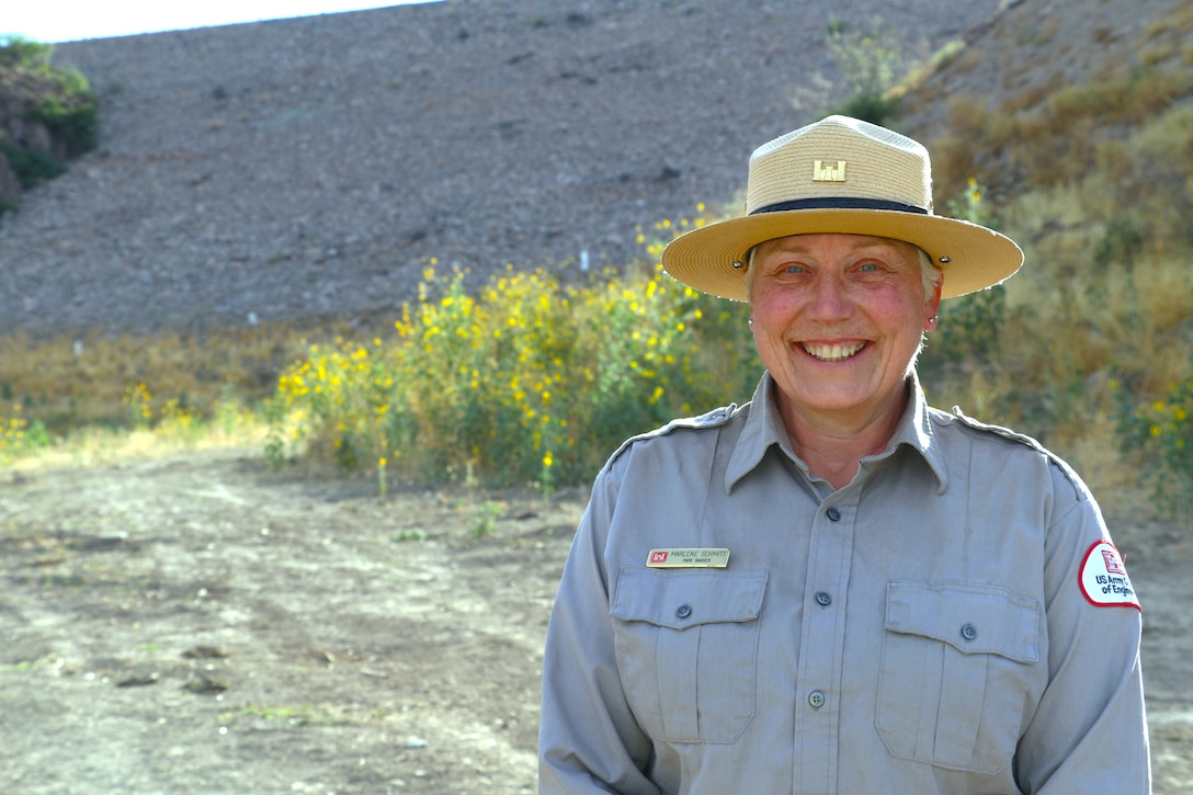 Marlene Schmitt, a park ranger with the U.S. Army Corps of Engineers Los Angeles District, poses for a photo upstream of Whitlow Range Dam after conducting an environmental compliance assessment of the area May 13 near Queen Valley, Arizona. Schmitt worked for the National Park Service as a seasonal park ranger at Mount Rainier National Park in Washington for six years prior to working with USACE. She has a master’s degree in environmental science from Washington State University.