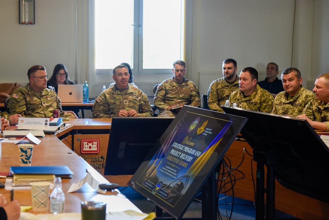 a group of people in military uniforms sitting around a table