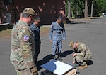 Airmen from the 242nd Combat Communications Squadron, Washington Air National Guard, talk through satellite set up training with Royal Thai Air Force counterparts during Enduring Partners 2026 at Camp Murray, June 2, 2026. Enduring Partners is an exchange that builds joint readiness by integrating U.S. and Thai forces in mission areas including ground-controlled interception, cyber, humanitarian aid and disaster relief, tactical air control party and space. Photo by Master Sgt. Brandy Burke.