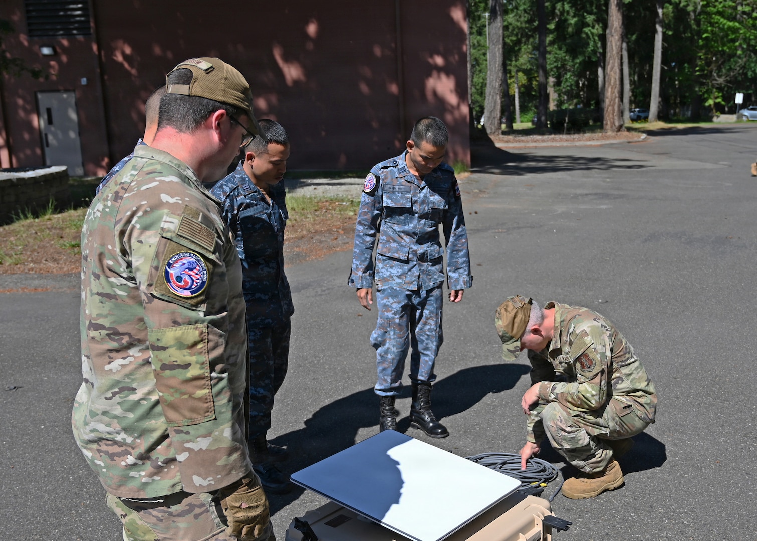 Airmen from the 242nd Combat Communications Squadron, Washington Air National Guard, talk through satellite set up training with Royal Thai Air Force counterparts during Enduring Partners 2026 at Camp Murray, June 2, 2026.