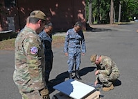 Airmen from the 242nd Combat Communications Squadron, Washington Air National Guard, talk through satellite set up training with Royal Thai Air Force counterparts during Enduring Partners 2026 at Camp Murray, June 2, 2026.