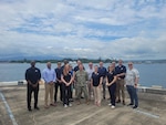 A group stands for a photo at a port