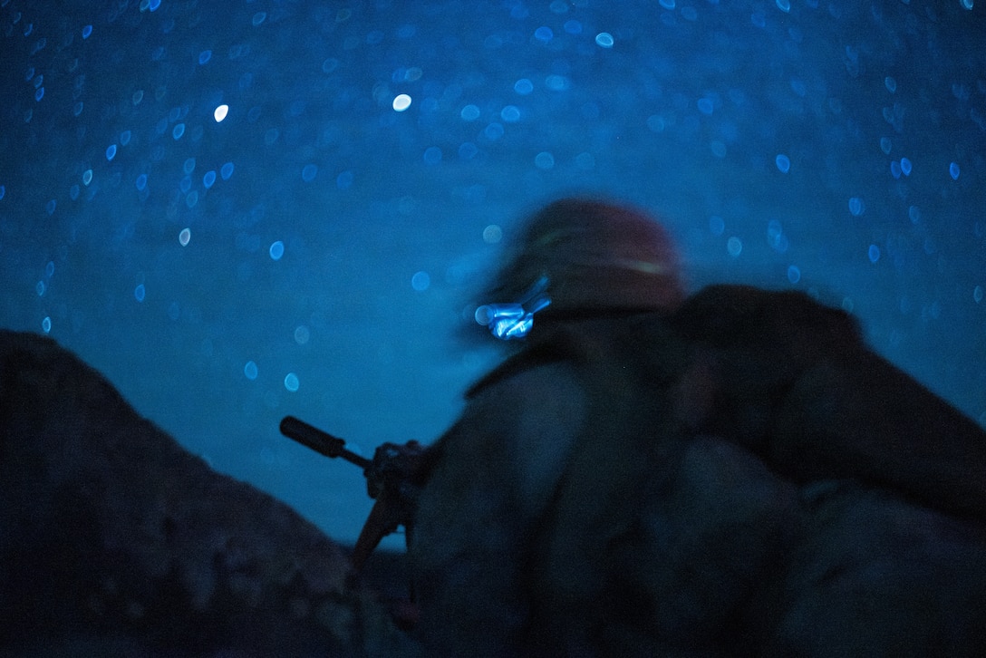 A U.S. Marine with 1st Battalion, 24th Marines, 4th Marine Division, goes to the prone position during a live fire night platoon attack on Range 410 Alpha as part of Integrated Training Exercise 3-26, Marine Corps Air Ground Combat Center Twentynine Palms, California, June 7, 2026. ITX is designed to generate combat readiness and ensure the Reserve Component provides critical strategic depth to the Total Force. From complex combined arms maneuvers to all-domain integration, these Marines are proving that they are ready to augment, reinforce, and fight alongside the active component at a moment's notice. (U.S. Marine Corps photo by Cpl. Van Hoang)