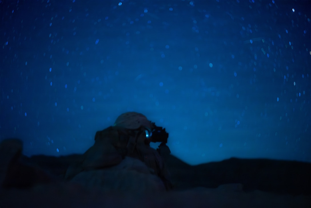 A U.S. Marine with 1st Battalion, 24th Marines, 4th Marine Division, communicates with his fireteam under simulated enemy fire during a live fire night platoon attack on Range 410 Alpha as part of Integrated Training Exercise 3-26, Marine Corps Air Ground Combat Center Twentynine Palms, California, June 7, 2026. ITX is designed to generate combat readiness and ensure the Reserve Component provides critical strategic depth to the Total Force. From complex combined arms maneuvers to all-domain integration, these Marines are proving that they are ready to augment, reinforce, and fight alongside the active component at a moment's notice. (U.S. Marine Corps photo by Cpl. Van Hoang)