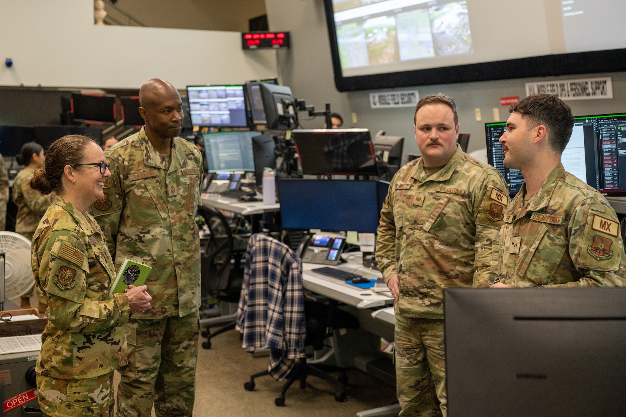 U.S. Air Force Maj. Gen. Stacy Jo Huser, 20th Air Force commander, and Chief Master Sgt. Nicholas Taylor, 20th Air Force command chief, speak with 341st Missile Wing Airmen in the Wing Operations Center at Malmstrom Air Force Base, Montana, June 1, 2026.