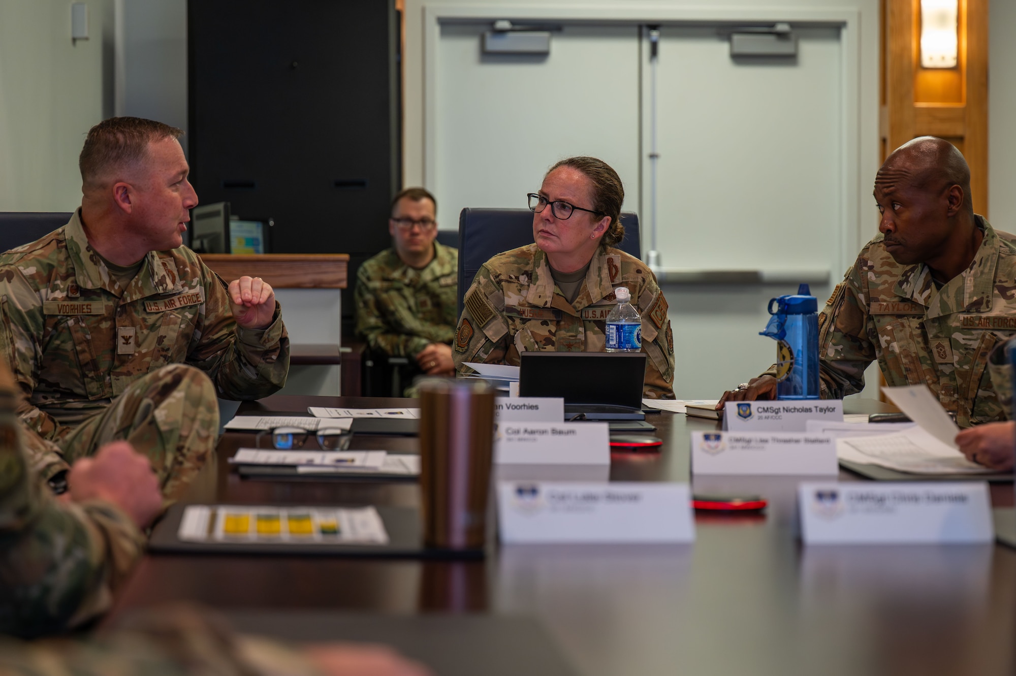 U.S. Air Force Maj. Gen. Stacy Jo Huser, center, 20th Air Force commander, and Chief Master Sgt. Nicholas Taylor, right, 20th Air Force command chief, discuss organizational priorities with Col. Daniel Voorhies, left, 341st Missile Wing commander, at Malmstrom Air Force Base, Montana, June 1, 2026.