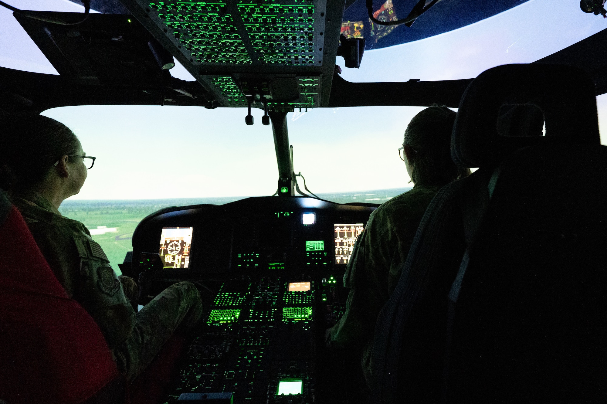 U.S. Air Force Maj. Gen. Stacy Jo Huser, left, 20th Air Force commander, operates an MH-139A Grey Wolf flight simulator under the instruction of Capt. Emily Hammer, right, 40th Helicopter Squadron tactical communications officer in charge, at Malmstrom Air Force Base, Montana, June 2, 2026.