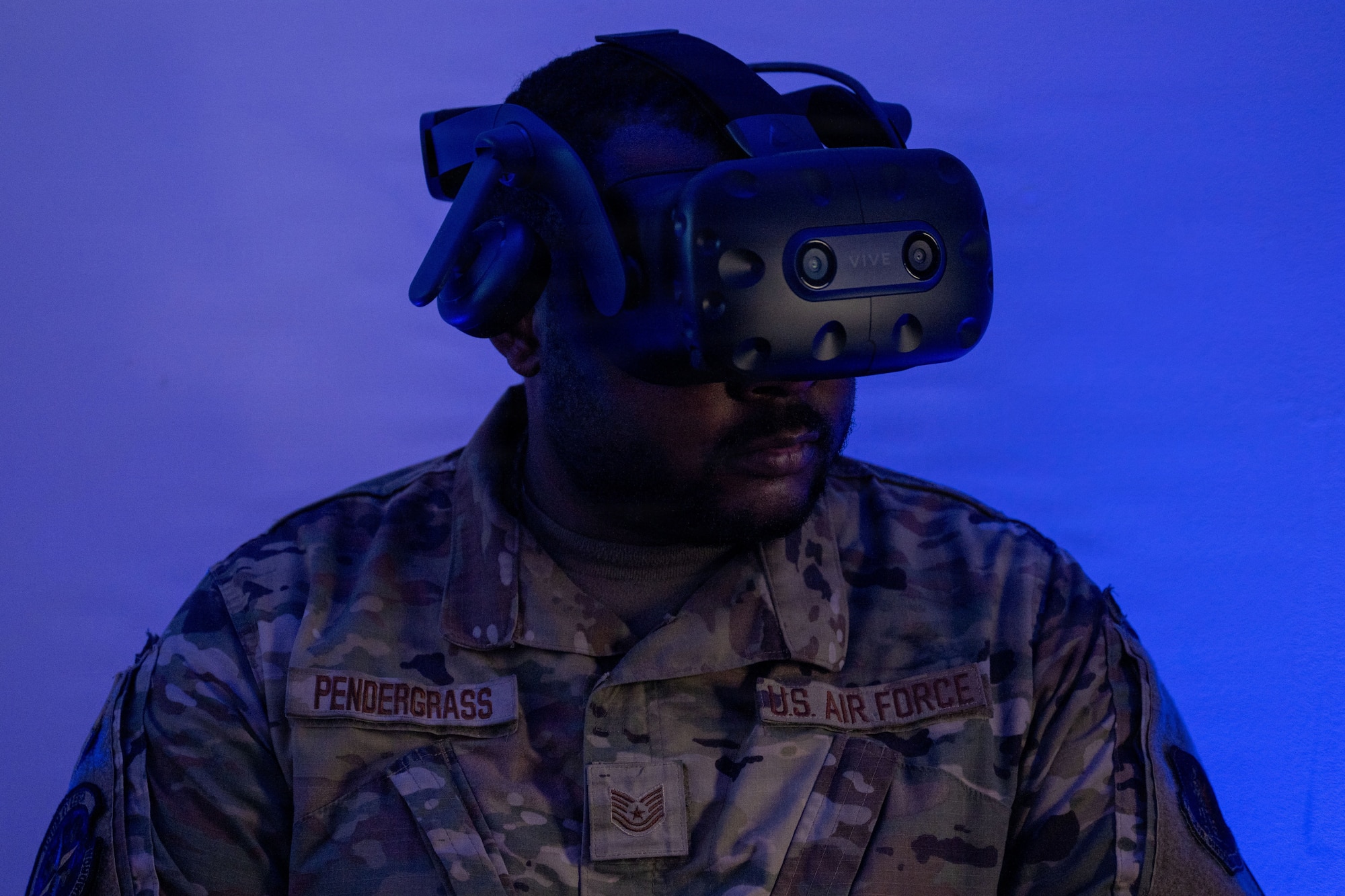 U.S. Air Force Tech. Sgt. Devondte Pendergrass uses a headset to look around the virtual flight line in the extended reality lab.
