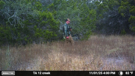Person in hunting gear from trail camera